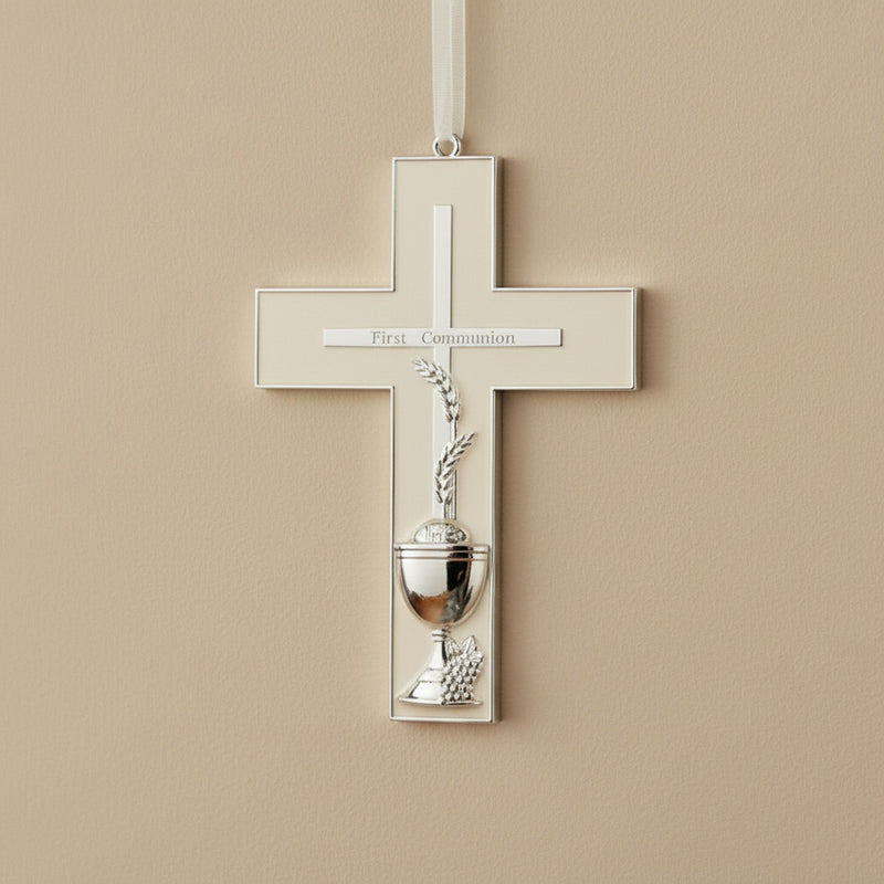 Decorative cross with chalice design on a beige wall, pointing towards 'First Communion'.