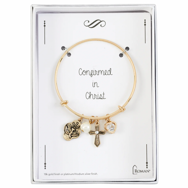 Gold Confirmation bracelet with charms on a branded card