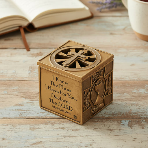 Multi sacrament engraved keepsake box with gold finish on a wood surface.