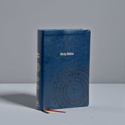 Blue leather-bound Bible with embossed design on a gray background