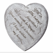 Heart-shaped stone with engraved text on a white background