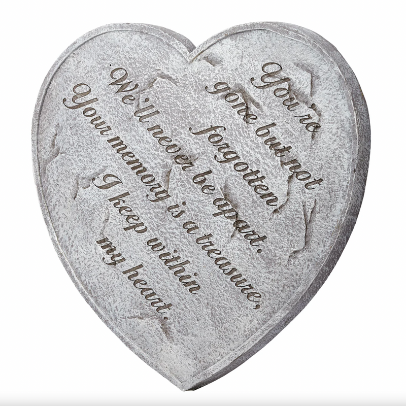 Heart-shaped stone with engraved text on a white background