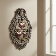 Decorative wall art with a heart design on a beige wall.