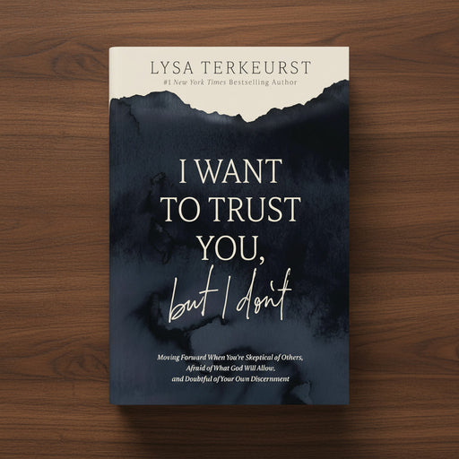 A navy blue book titled 'I Want to Trust You, But I Don't' on a dark wood surface