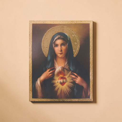 Framed artwork of the Immaculate Heart of Mary with a gold frame on a beige wall.