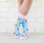Person wearing pastel pink and blue socks with images of the Immaculate Heart of Mary