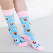 Person wearing pastel pink and blue socks with images of the Immaculate Heart of Mary