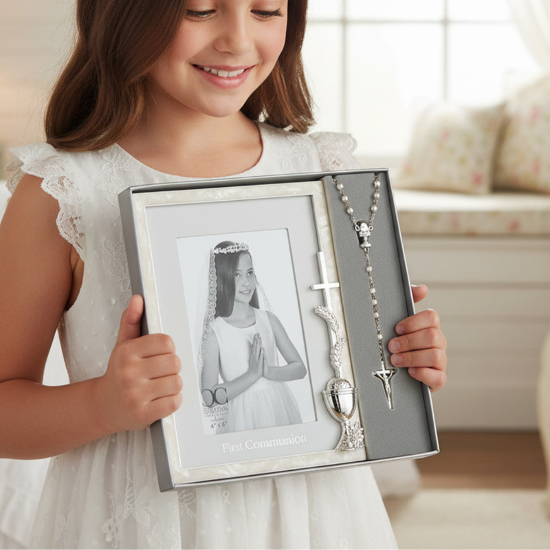 Young girl holding a First Communion boxed picture frame for a 4x6 inch photo and a rosary.