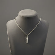 Silver necklace with a Sacred Heart of Jesus pendant on a gray mannequin bust against a gray background