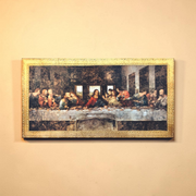 Framed artwork resembling 'The Last Supper' on a beige wall