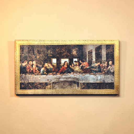 Framed artwork resembling 'The Last Supper' on a beige wall