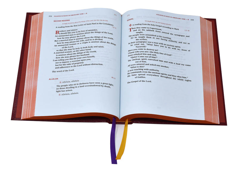 Red liturgical book with Gospel text on a white background