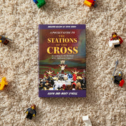 Book titled 'A Pocket Guide to the Stations of the Cross' on a carpet with toy figures around it.