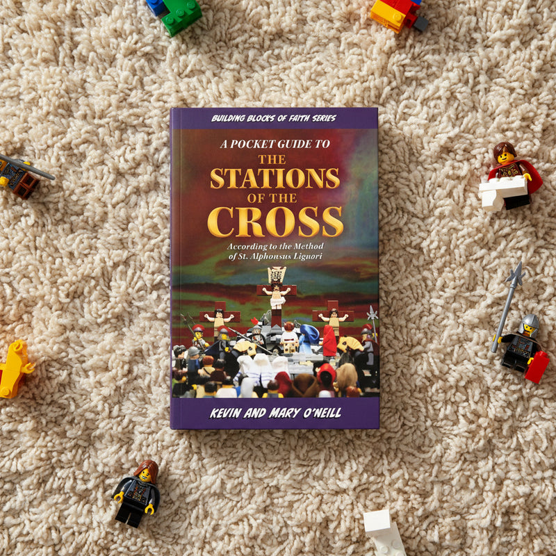 Book titled 'A Pocket Guide to the Stations of the Cross' on a carpet with toy figures around it.