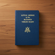 Blue book titled 'Little Office of the Blessed Virgin Mary' on a wooden surface