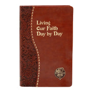 Brown leather notebook with decorative spine and text 'Living Our Faith Day by Day' on a white background