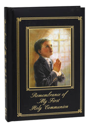 Memorabilia album with a cover featuring a boy praying and the text 'Remembrance of My First Holy Communion'.