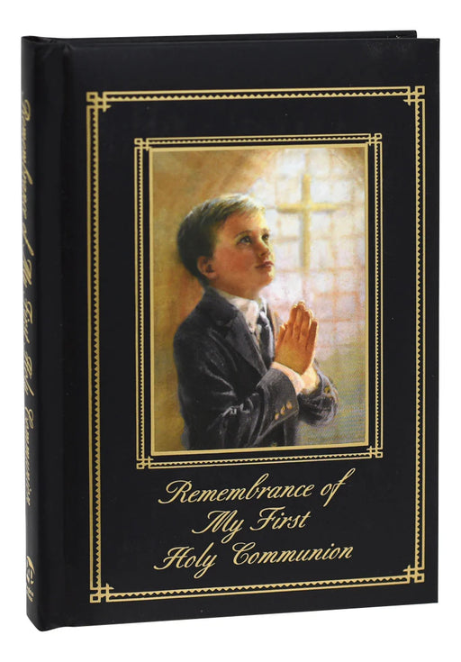 Memorabilia album with a cover featuring a boy praying and the text 'Remembrance of My First Holy Communion'.