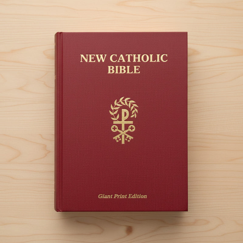 Red New Catholic Bible on a wooden surface