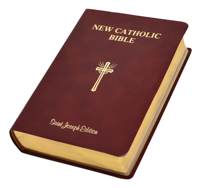 New Catholic Bible with a gold cross on a white background