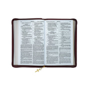 Open Bible inside a brown leather cover with a gold cross charm on a white background