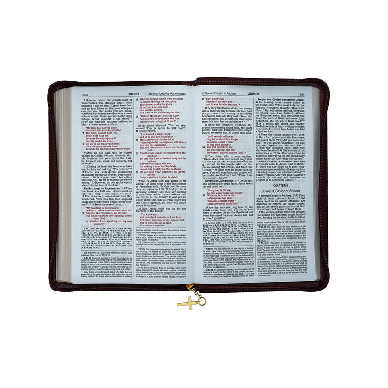 Bible with a maroon cover and gold cross charm on a white background