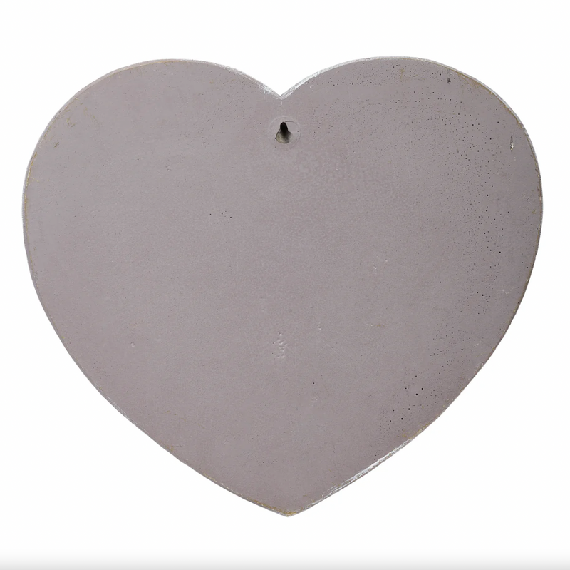 Heart-shaped concrete stone on a white background