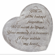 Heart-shaped stone with engraved text on a white background