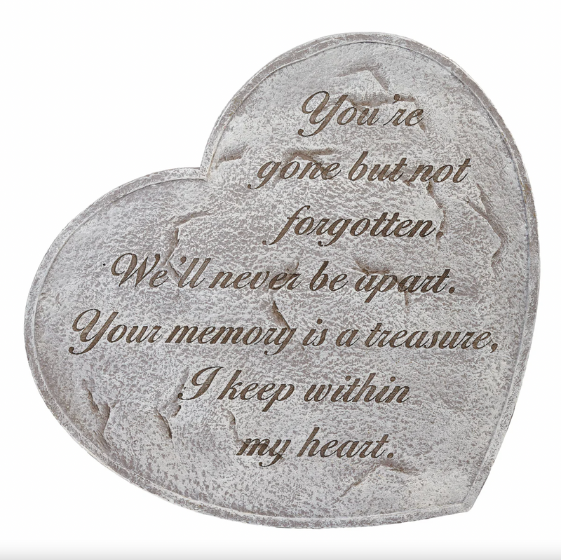 Heart-shaped stone with engraved text on a white background