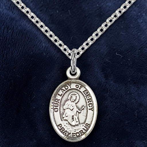 Silver 'Our Lady of Mercy' pendant necklace on a dark blue background