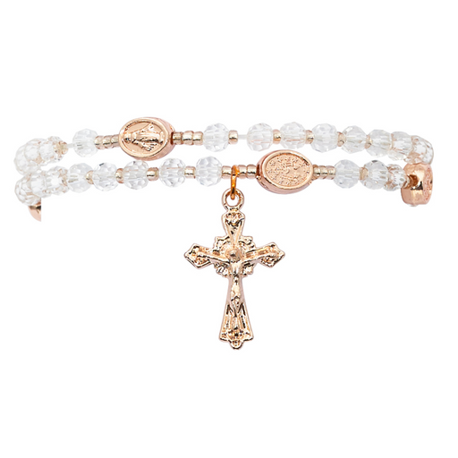 Rose gold rosary bracelet with clear beads and a cross pendant on a white background