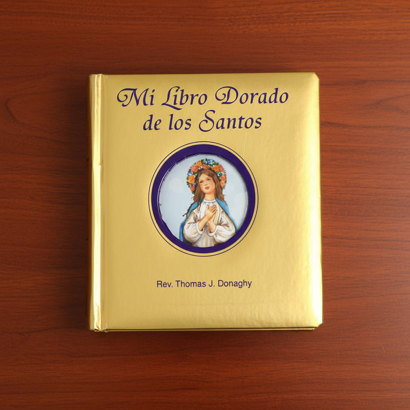 Gold book titled 'Mi Libro Dorado de los Santos' on a wooden surface