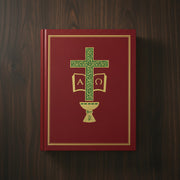 Red book with green cross and symbols on a wooden surface