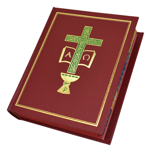 Red book with green and gold cross design on a white background