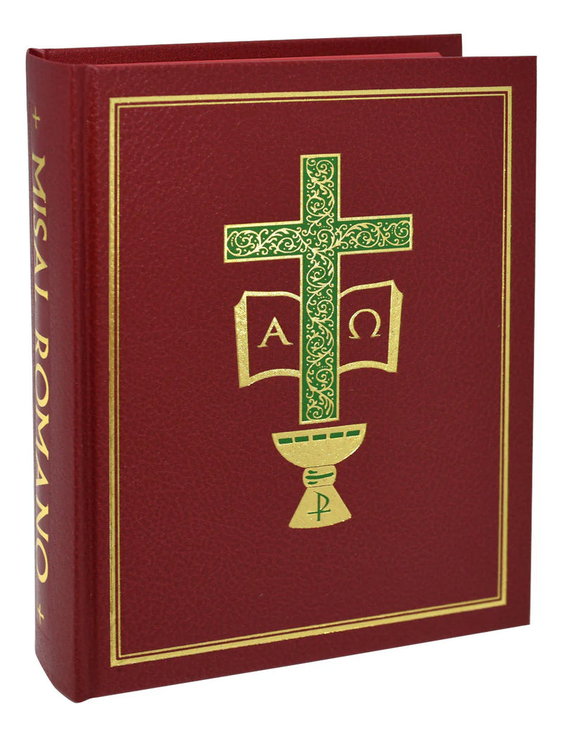 Red book with gold and green cross design on a white background