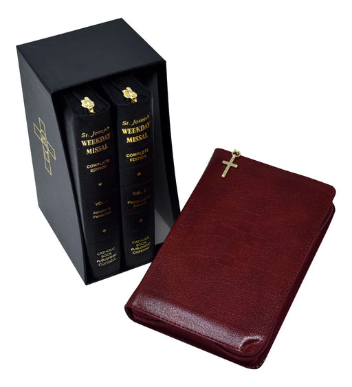 Red leather book with gold cross on a white background