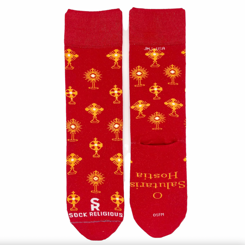 Vibrant red and gold socks featuring images of different monstrances with the Blessed Sacrament on a white background