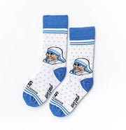 A person in white socks with blue accents and an image of Mother Teresa