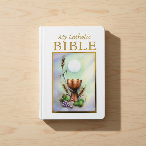 White Bible with 'My Catholic Bible' text and chalice illustration on a wooden surface