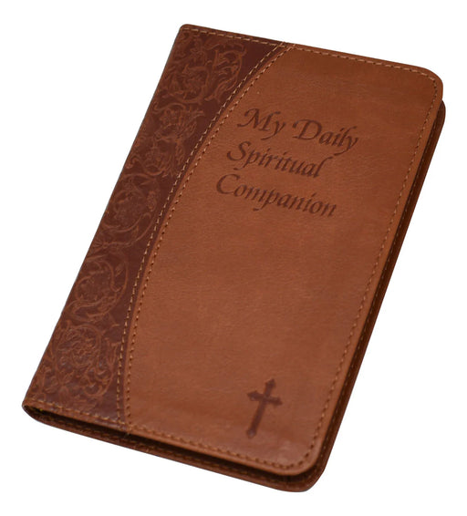 Brown leather book with 'My Daily Spiritual Companion' text and cross design on a white background