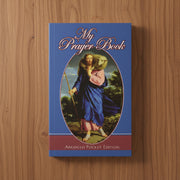 Book titled 'My Prayer Book' with a cover illustration on a wooden surface