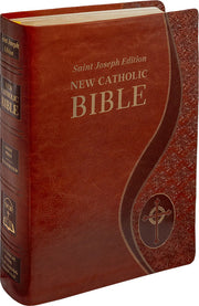 Brown leather-bound New Catholic Bible with cross emblem on a white background