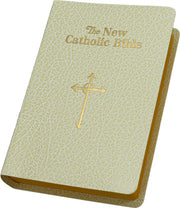 New Catholic Bible with gold cross on a white background