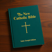 Green Bible with gold text and cross on a wooden surface