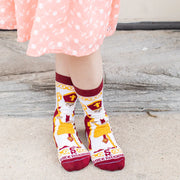 Child wearing brightly colored St. Nicholas socks