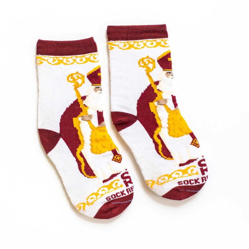 A pair of red, white, and gold socks featuring images of St. Nicholas holding a crosure