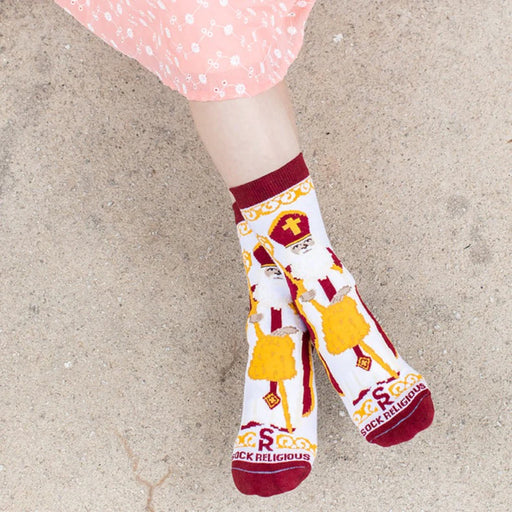 Child wearing brightly colored St. Nicholas socks