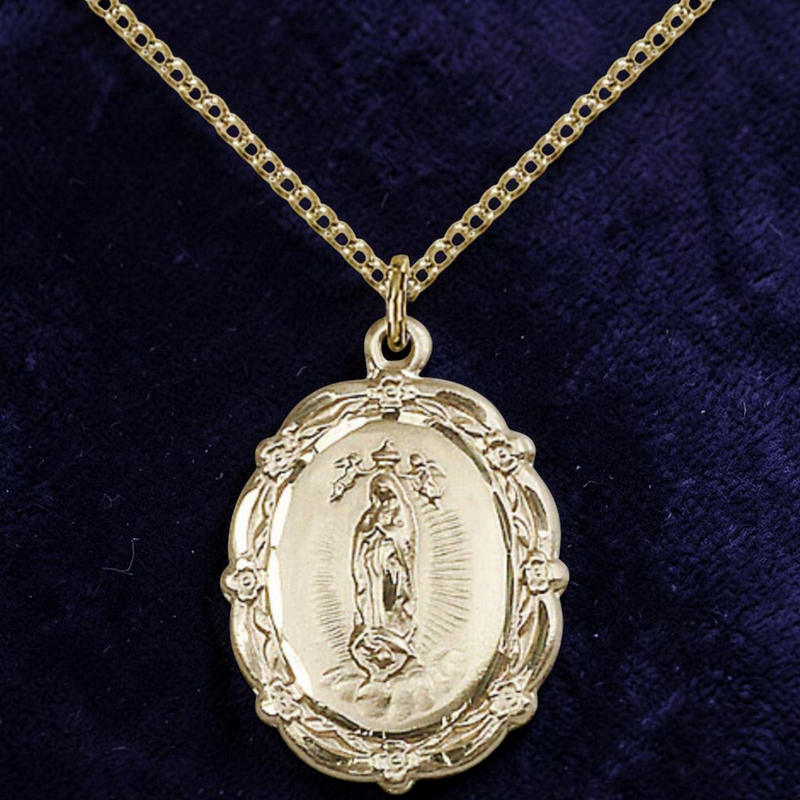 Gold religious pendant necklace on a dark blue velvet background