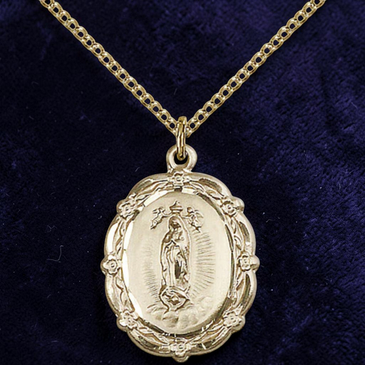 Gold religious pendant necklace on a dark blue velvet background