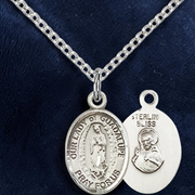 Silver religious pendant necklace on a dark blue background